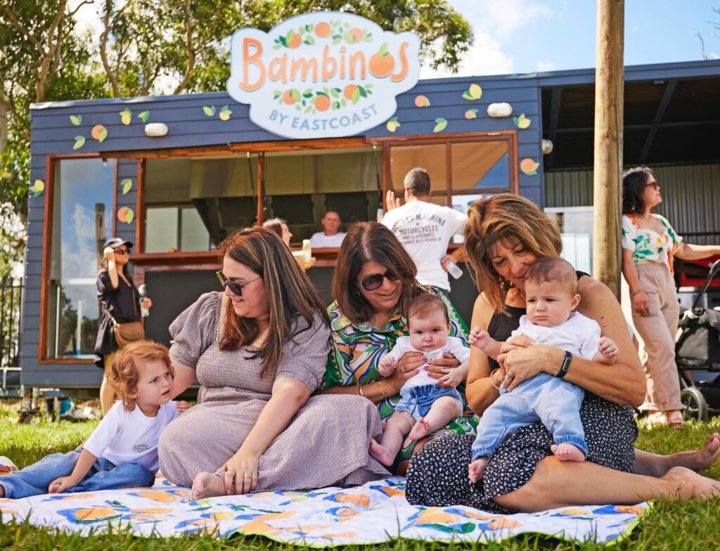 Three ladies are sitting with their babies at Eastcoast Farm by Eastcoast.